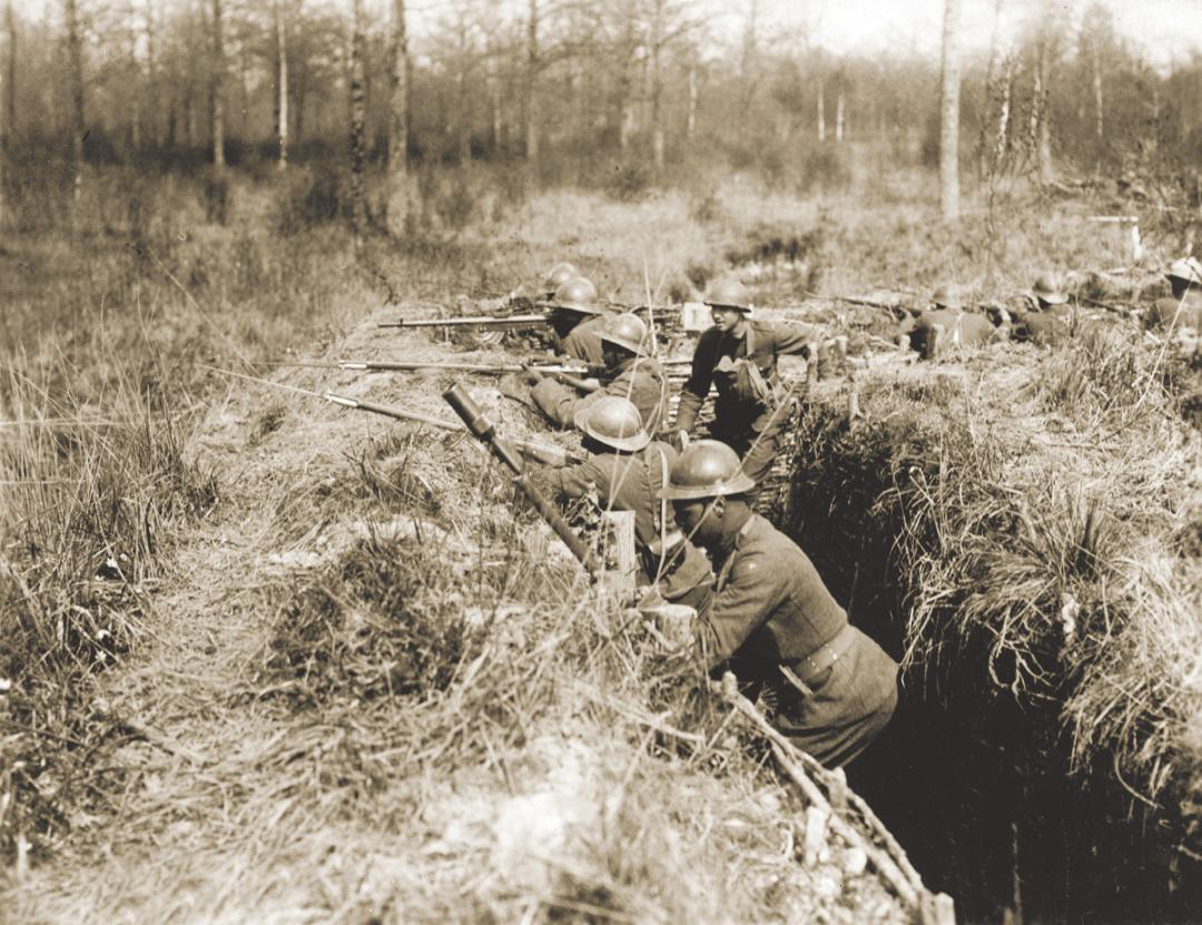 Soldiers of the 369th Infantry Regiment man a trench in France during World War I